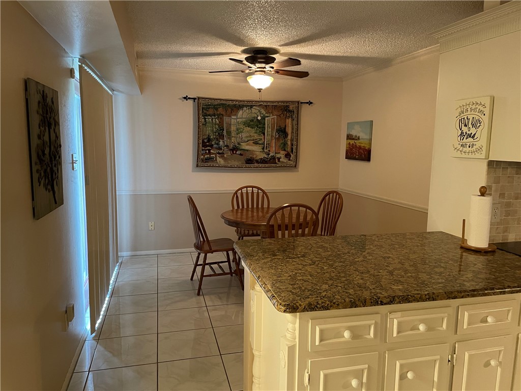 5218 Wooldridge Road Corpus Christi, TX 78413 - Photo 8 of 29 a kitchen with a table chairs and a refrigerator