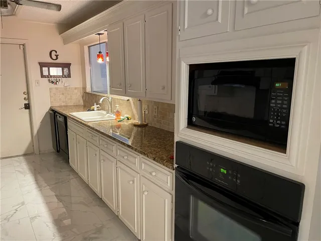 a kitchen with a sink and a microwave