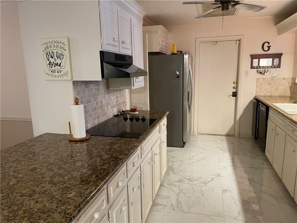 5218 Wooldridge Road Corpus Christi, TX 78413 - Photo 10 of 29 a kitchen with stainless steel appliances granite countertop a sink and a refrigerator