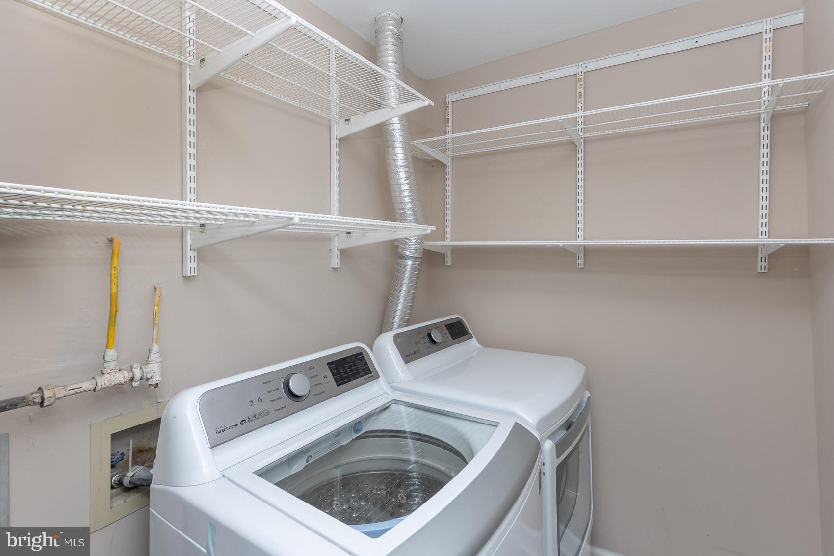 6832 I Hayley Ridge Way, Unit I Baltimore, MD 21209 - Photo 23 of 31 Modern laundry space with ample storage.