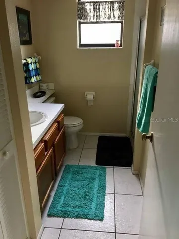 a bathroom with a toilet a sink and a vanity