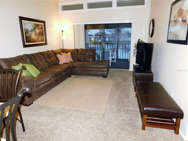 a living room with furniture gym equipment and a large window