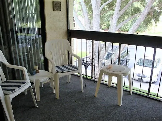a view of a porch with chairs and backyard