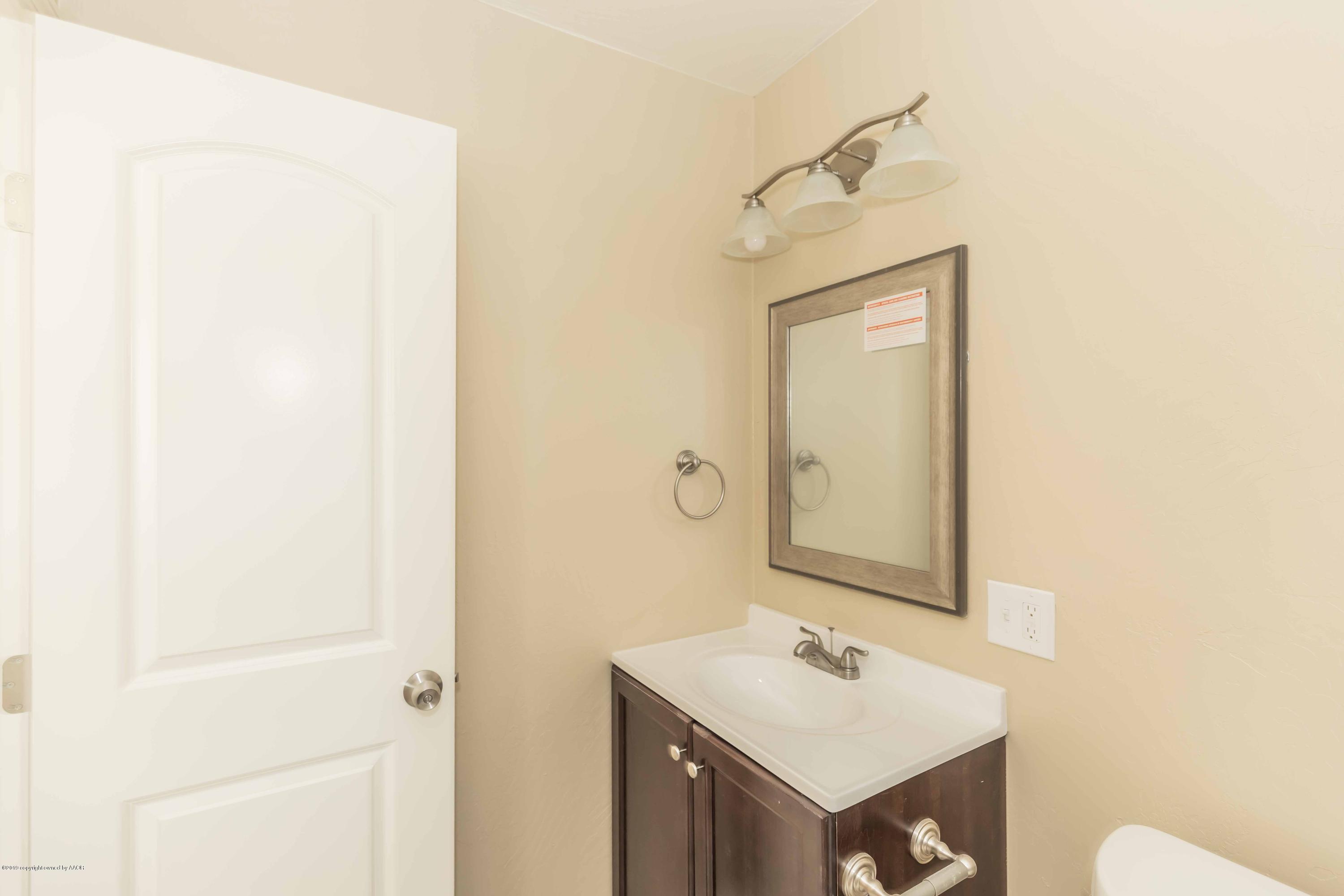 1410 Southwest 46th Avenue Amarillo, TX 79110 - Photo 16 of 29 a bathroom with a sink and a mirror