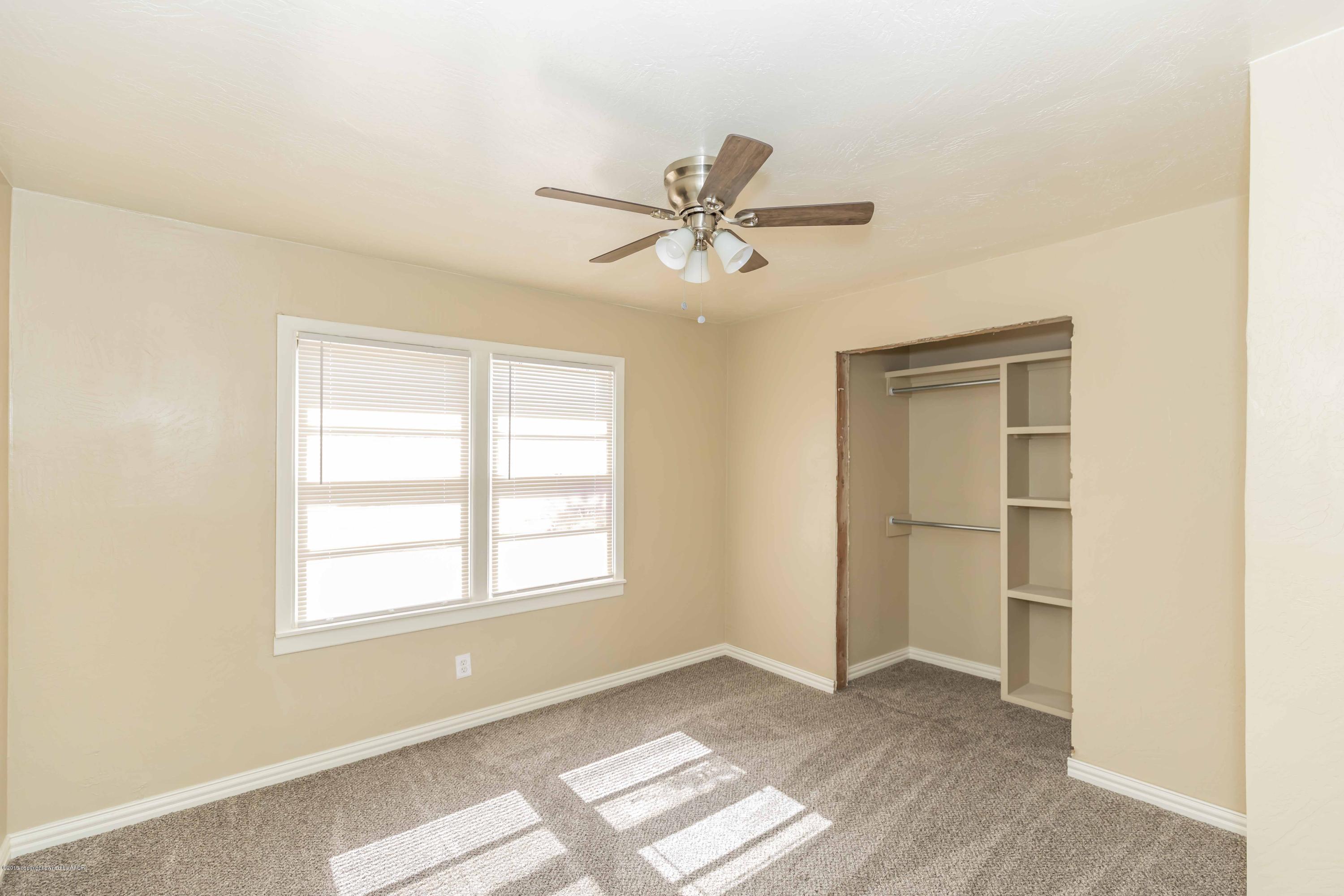 1410 Southwest 46th Avenue Amarillo, TX 79110 - Photo 17 of 29 a view of a livingroom with a window and a ceiling fan
