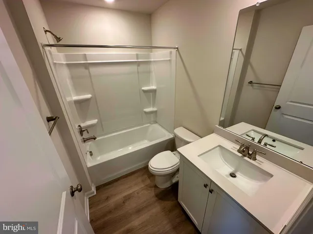 a bathroom with a sink mirror vanity and toilet