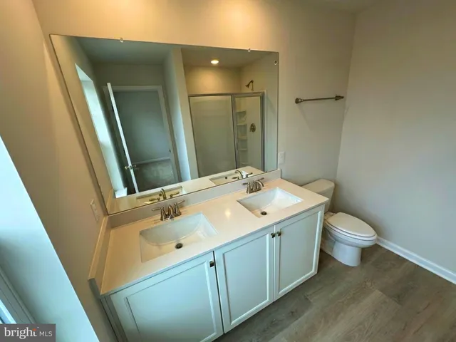 a bathroom with a sink a toilet and mirror