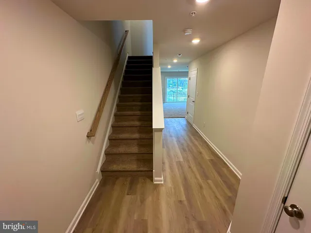 a view of entryway and hall with wooden floor