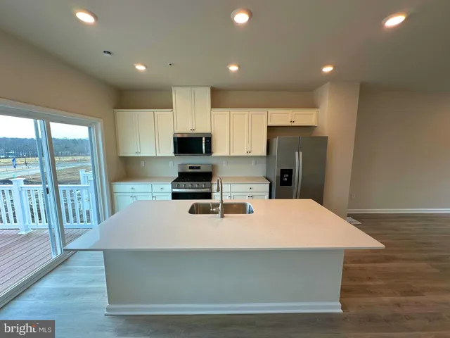 a kitchen with a appliances a refrigerator and a stove top oven