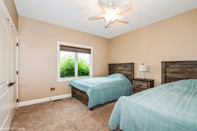 a bedroom with two beds and a chandelier