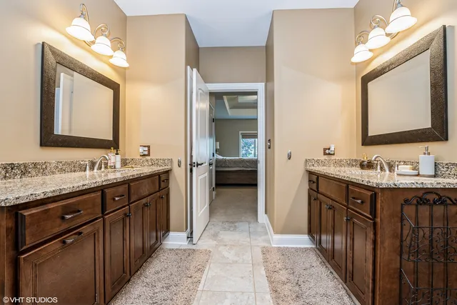 a bathroom with a double vanity sink and a mirror