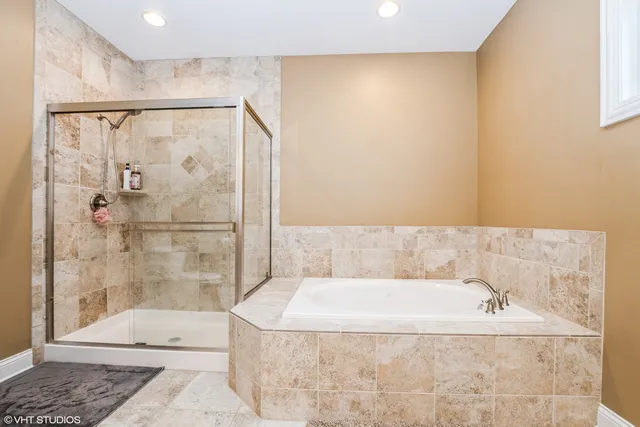 a bathroom with a bathtub and shower