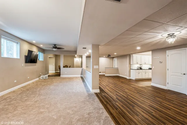 a view of a living room a flat screen tv and kitchen view