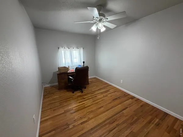 a room with a window and a chandelier