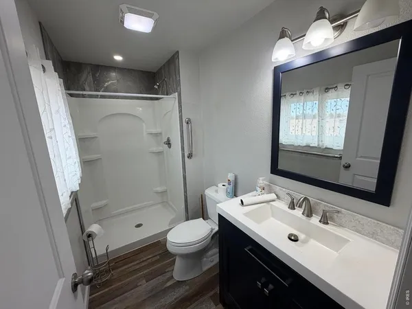 a kitchen with a refrigerator and white cabinets