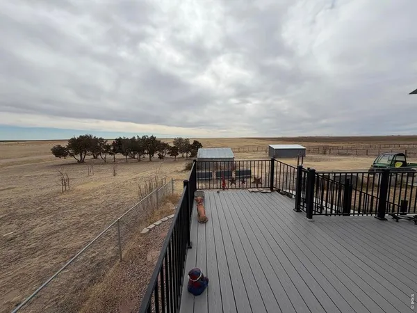 a view of outdoor space with deck and lake view
