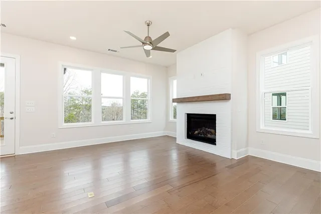 a view of an empty room with window and fire place