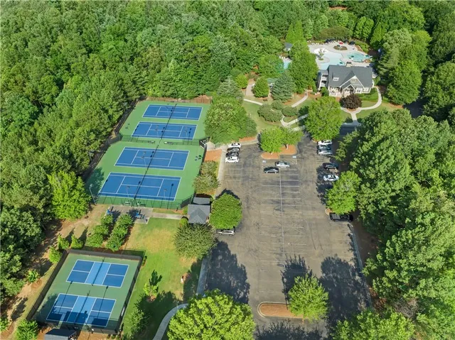 an aerial view of multiple houses with yard
