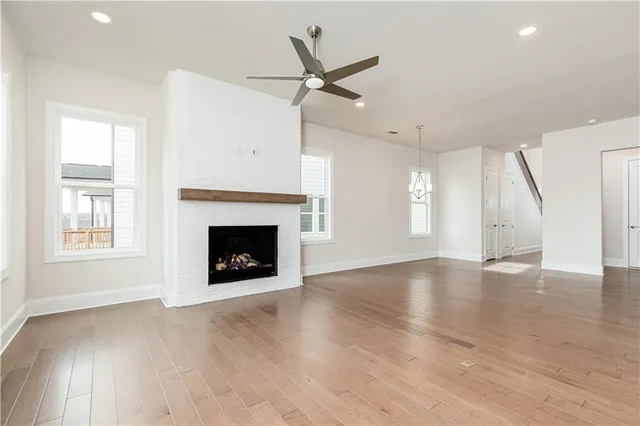 an empty room with windows and a fireplace