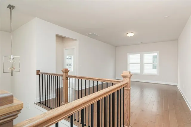 a view of hallway with wooden floor