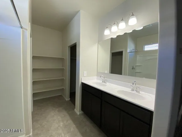 a bathroom with a double vanity sink and a mirror