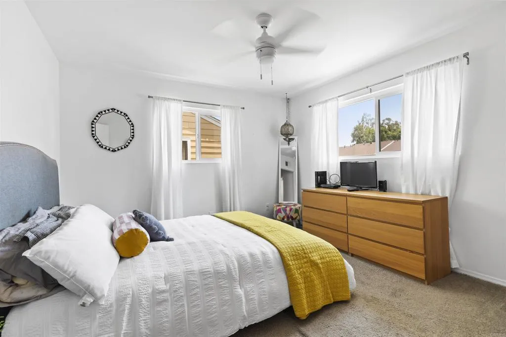 7883 Rancho Fanita Drive, Unit A Santee, CA 92071 - Photo 13 of 27 a bedroom with a bed and a window