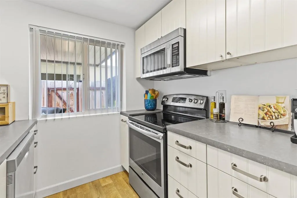 7883 Rancho Fanita Drive, Unit A Santee, CA 92071 - Photo 2 of 27 a kitchen with granite countertop a stove and a sink