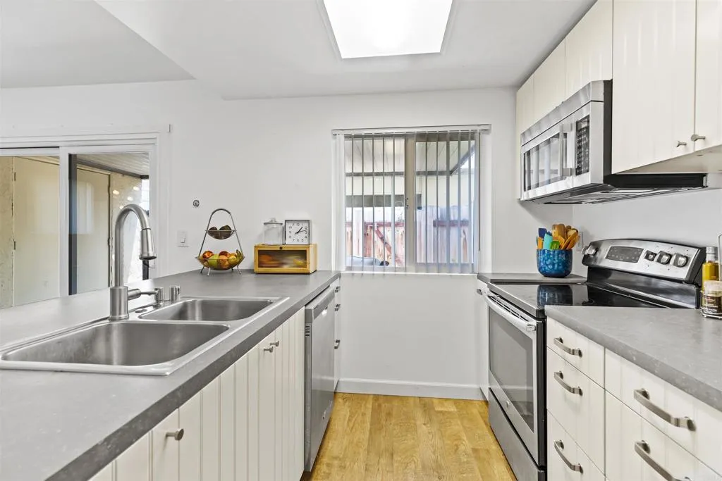 7883 Rancho Fanita Drive, Unit A Santee, CA 92071 - Photo 5 of 27 a kitchen with a sink and a refrigerator