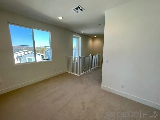 en empty room with windows and closet