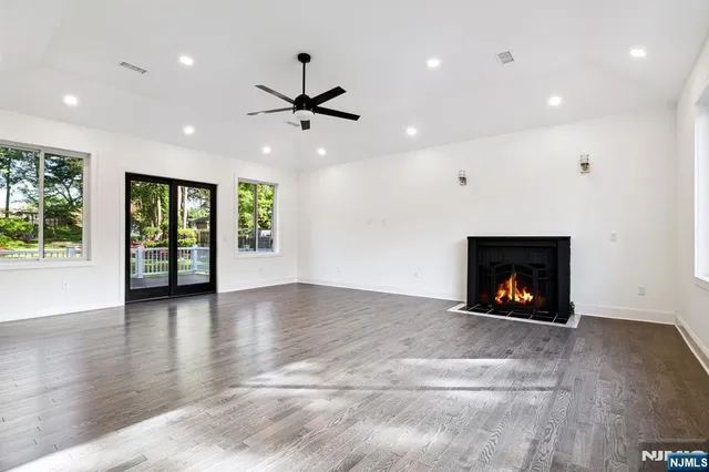 a view of an empty room with a fireplace and a window