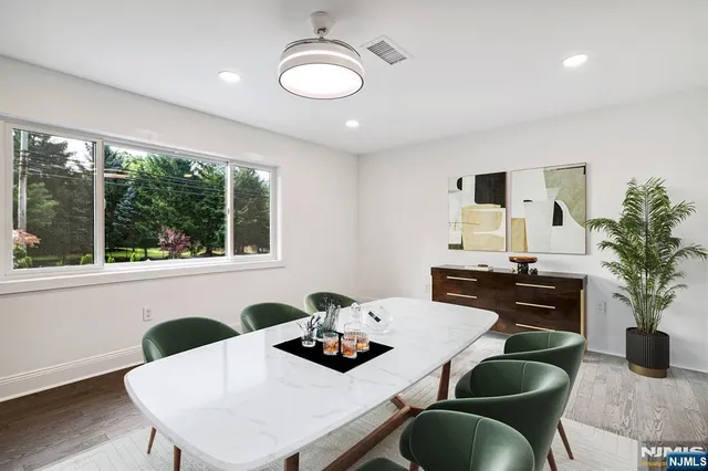 a dining room with furniture and wooden floor