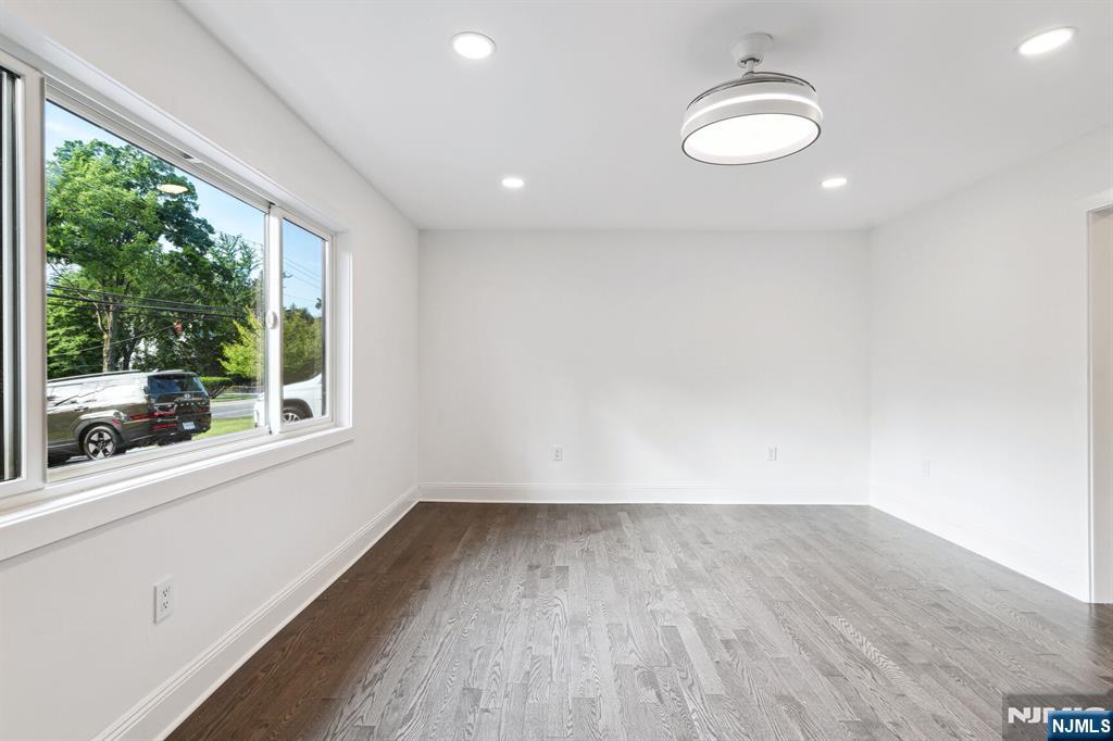 291 Tappan Road Norwood, NJ 07648 - Photo 16 of 26 an empty room with wooden floor and windows