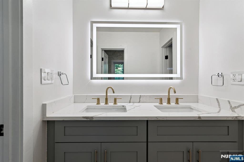 291 Tappan Road Norwood, NJ 07648 - Photo 17 of 26 a bathroom with a sink and a mirror