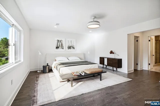 a bedroom with a bed and a tv