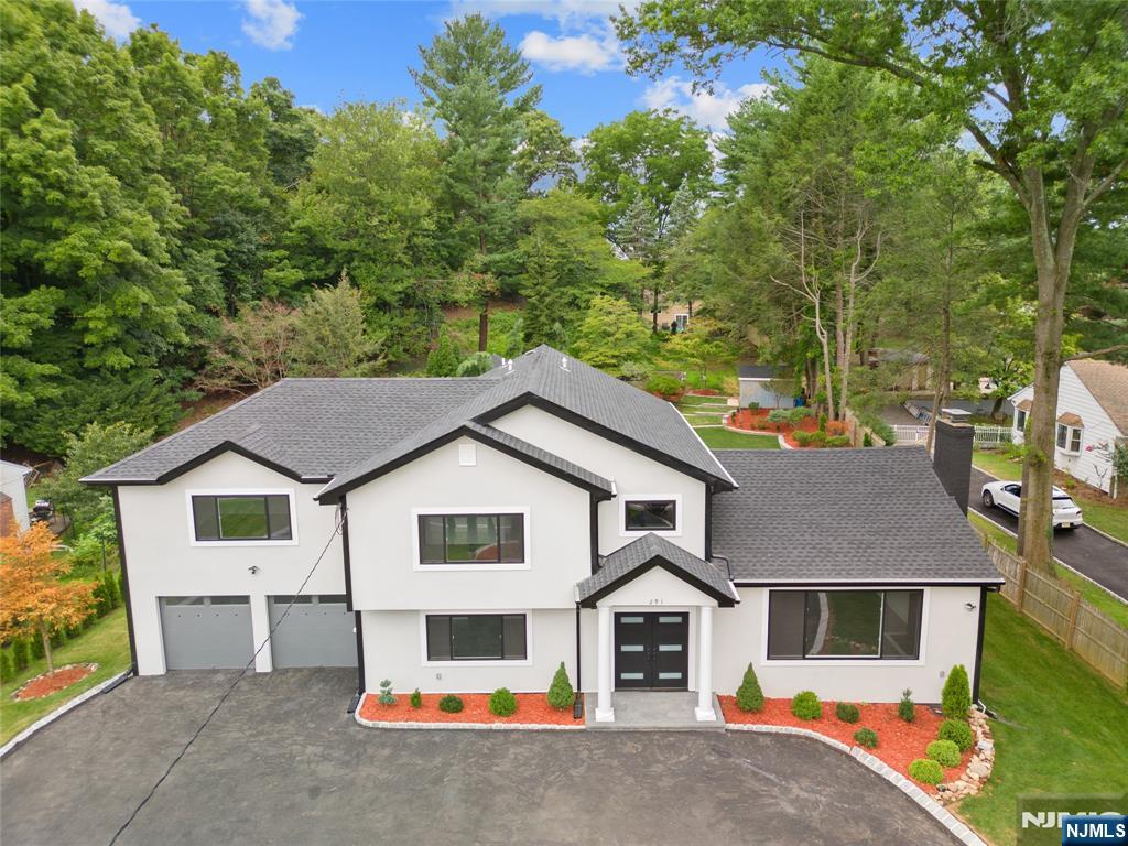 291 Tappan Road Norwood, NJ 07648 - Photo 2 of 26 a view of a white house with a yard and large trees
