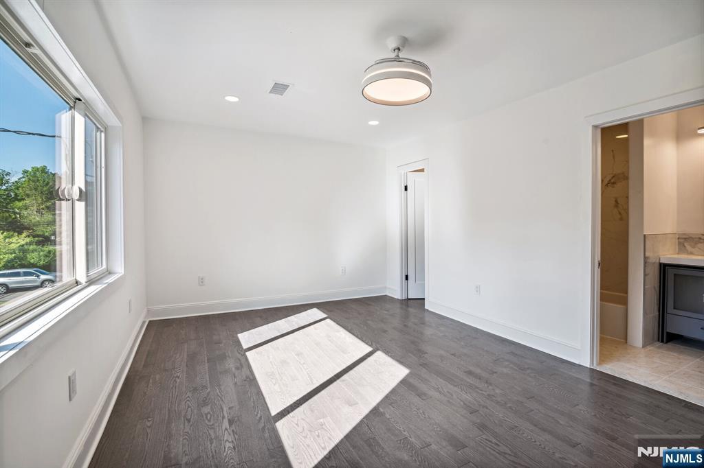 291 Tappan Road Norwood, NJ 07648 - Photo 23 of 26 an empty room with wooden floor and windows