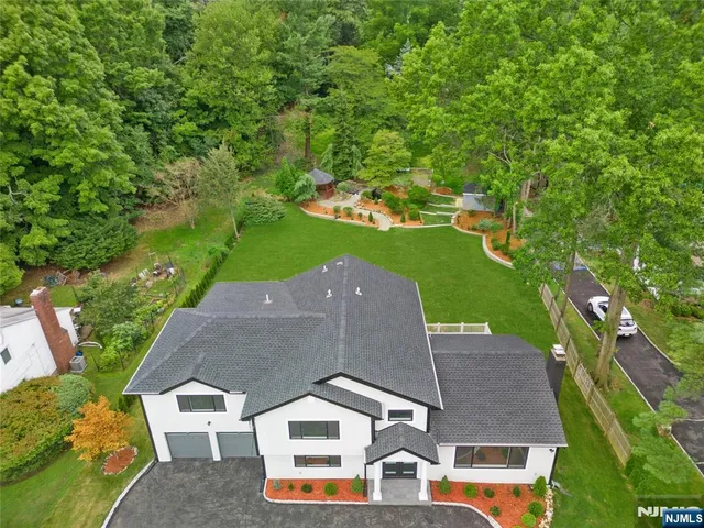 an aerial view of a house with a yard