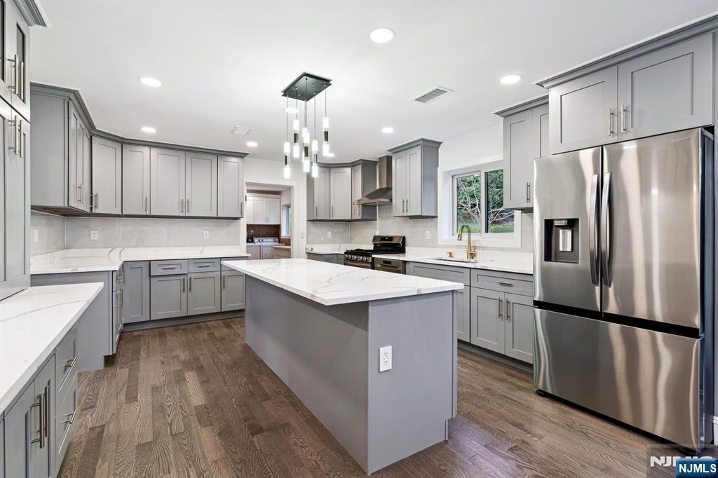 291 Tappan Road Norwood, NJ 07648 - Photo 8 of 26 a kitchen with kitchen island granite countertop a sink refrigerator and cabinets