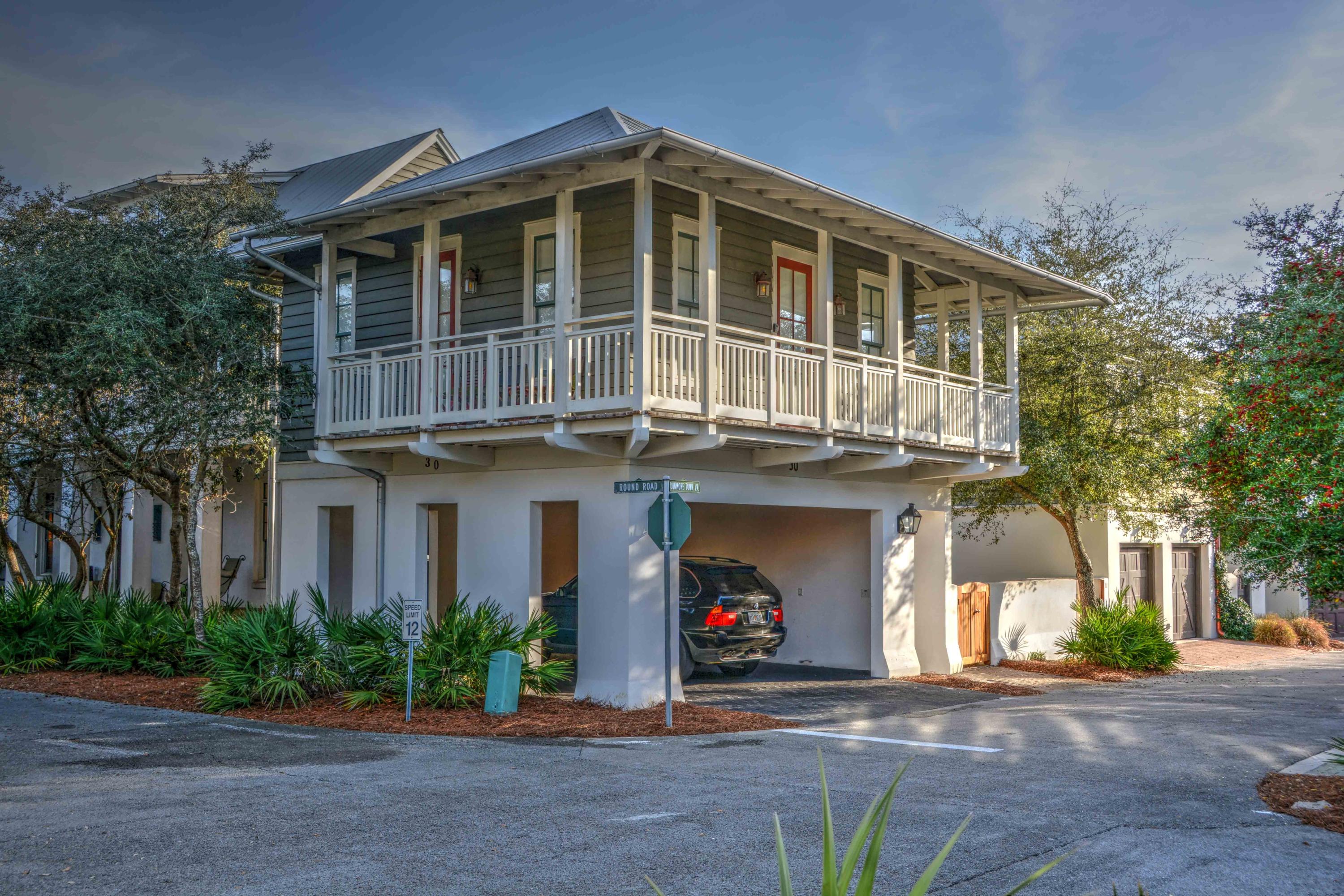 54 Round Road Rosemary Beach, FL 32461 - Photo 43 of 48 a front view of a house with a yard and a garage