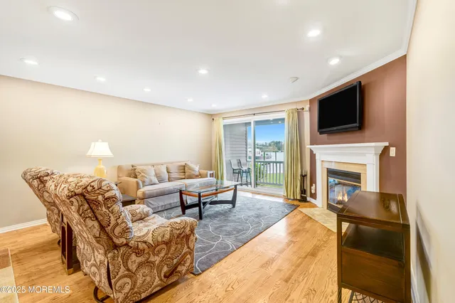 a living room with a fireplace and a flat screen tv