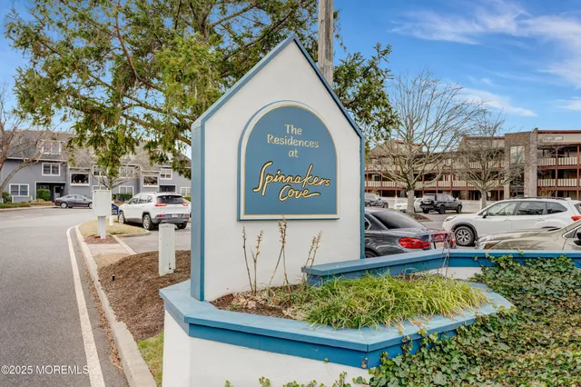 a kitchen with stainless steel appliances kitchen island granite countertop a table chairs sink and cabinets