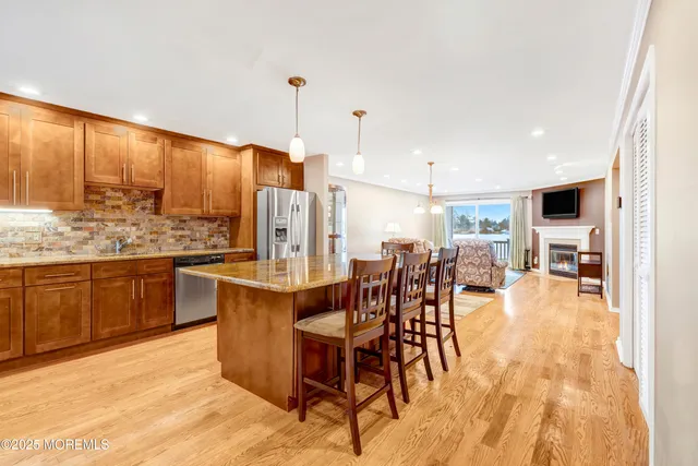 a kitchen with stainless steel appliances granite countertop a stove a sink and a refrigerator