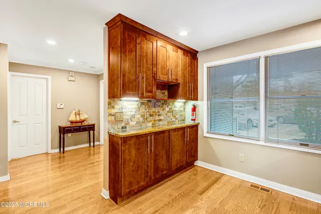 a kitchen with stainless steel appliances granite countertop wooden cabinets stove top oven and sink