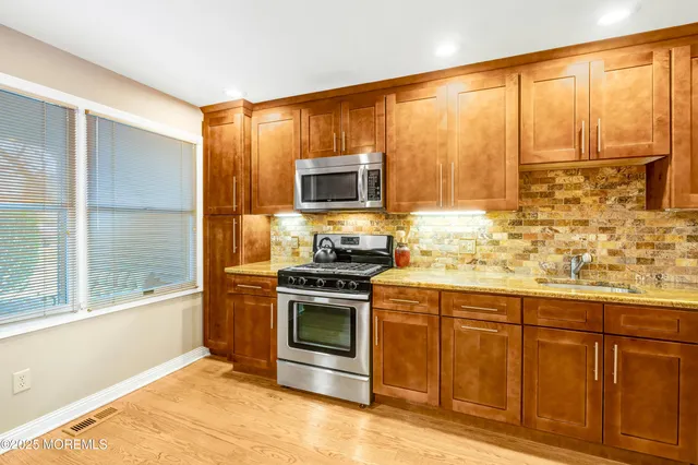 a dining room with furniture and a floor to ceiling window