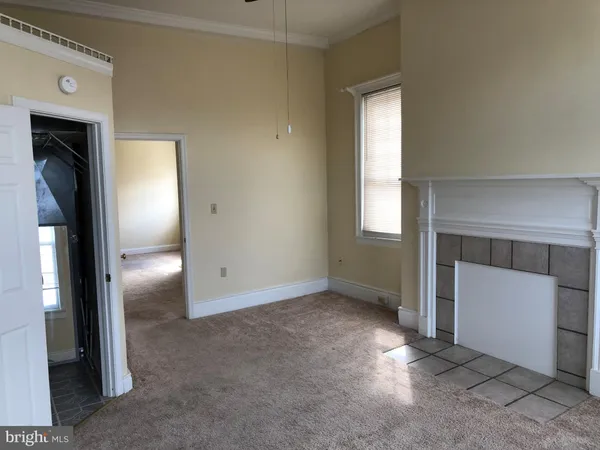 an empty room with windows and closet