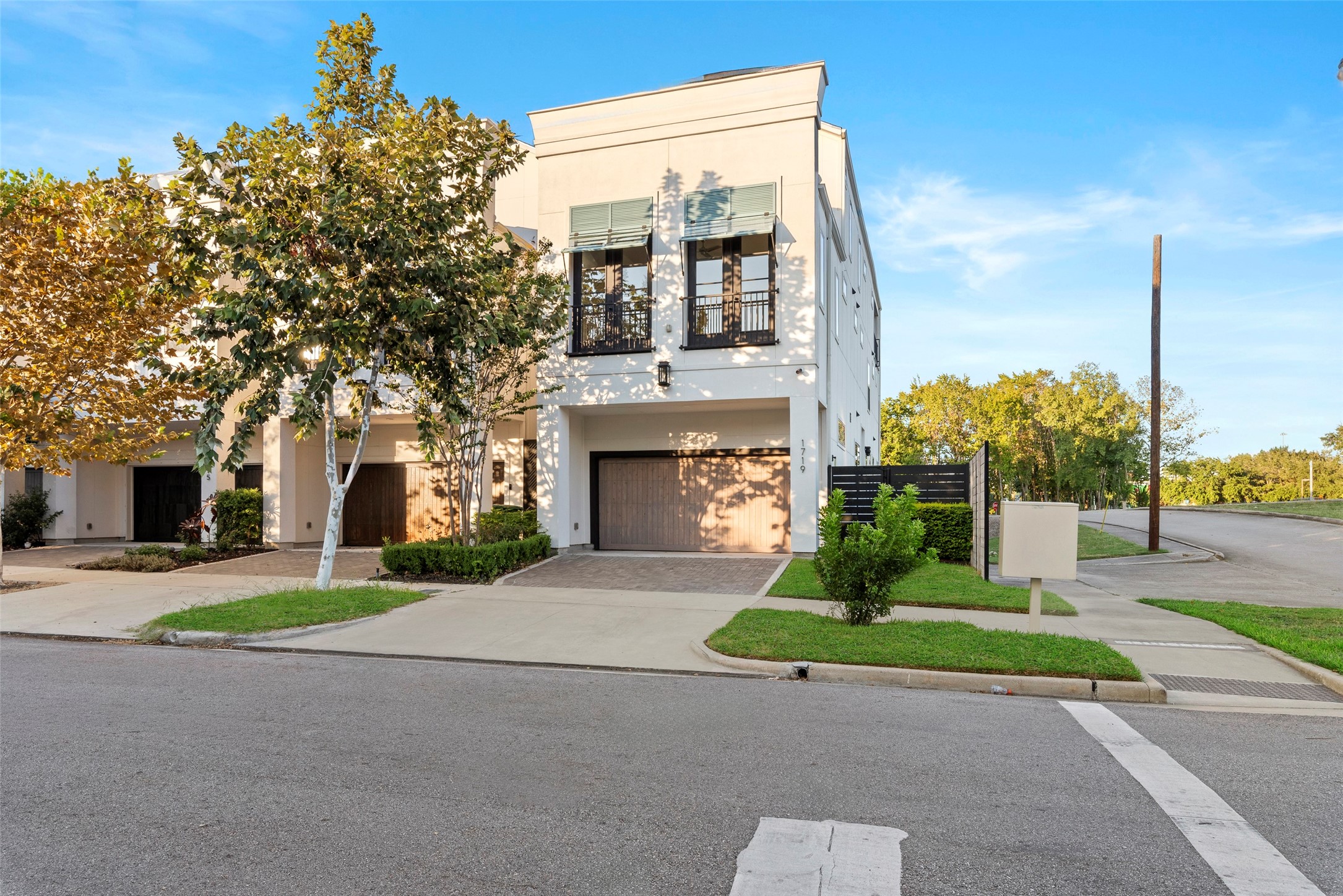 1719 Holman Street Houston, TX 77004 - Photo 3 of 40 a front view of a house with a garden and trees