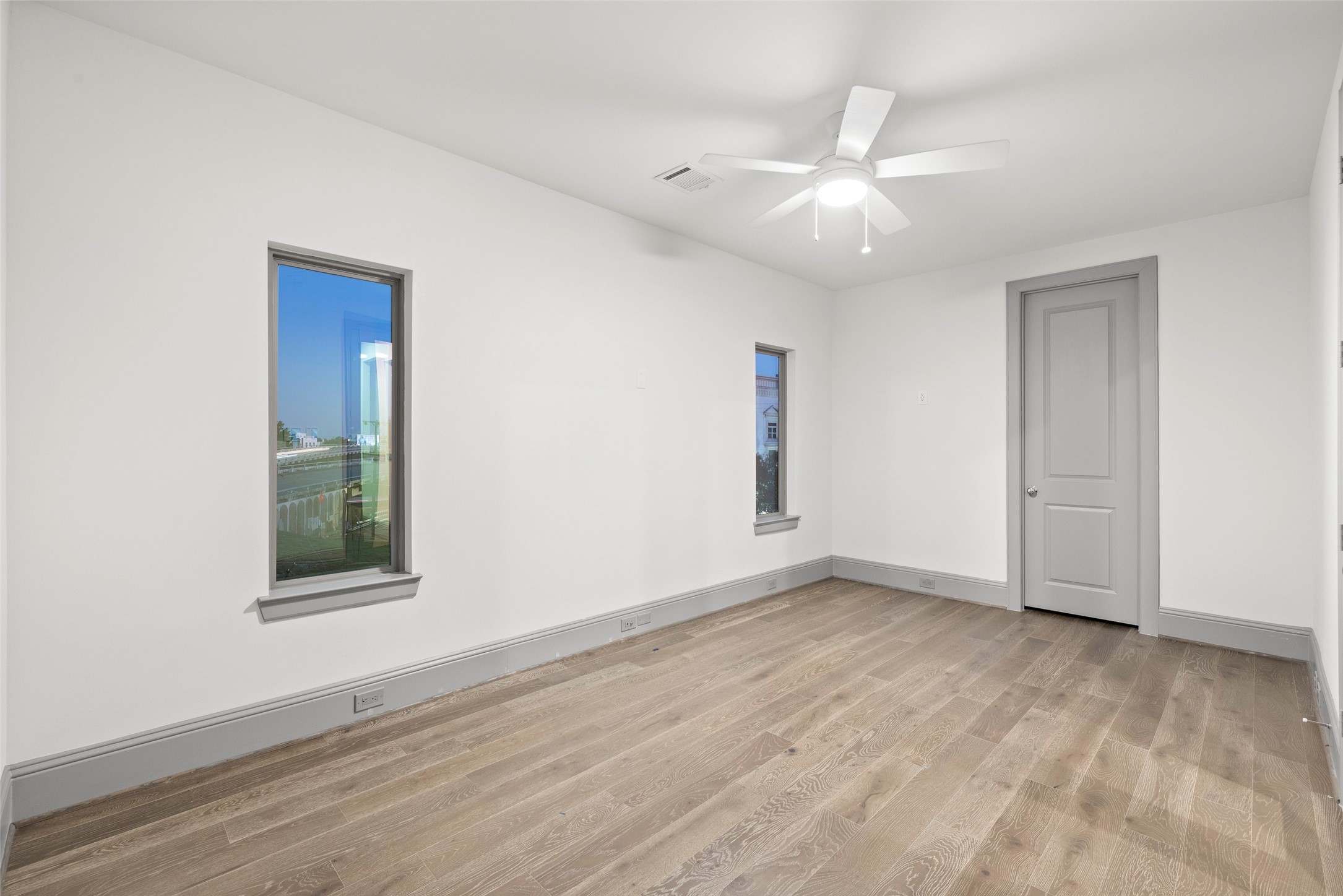 1719 Holman Street Houston, TX 77004 - Photo 36 of 40 an empty room with wooden floor and windows