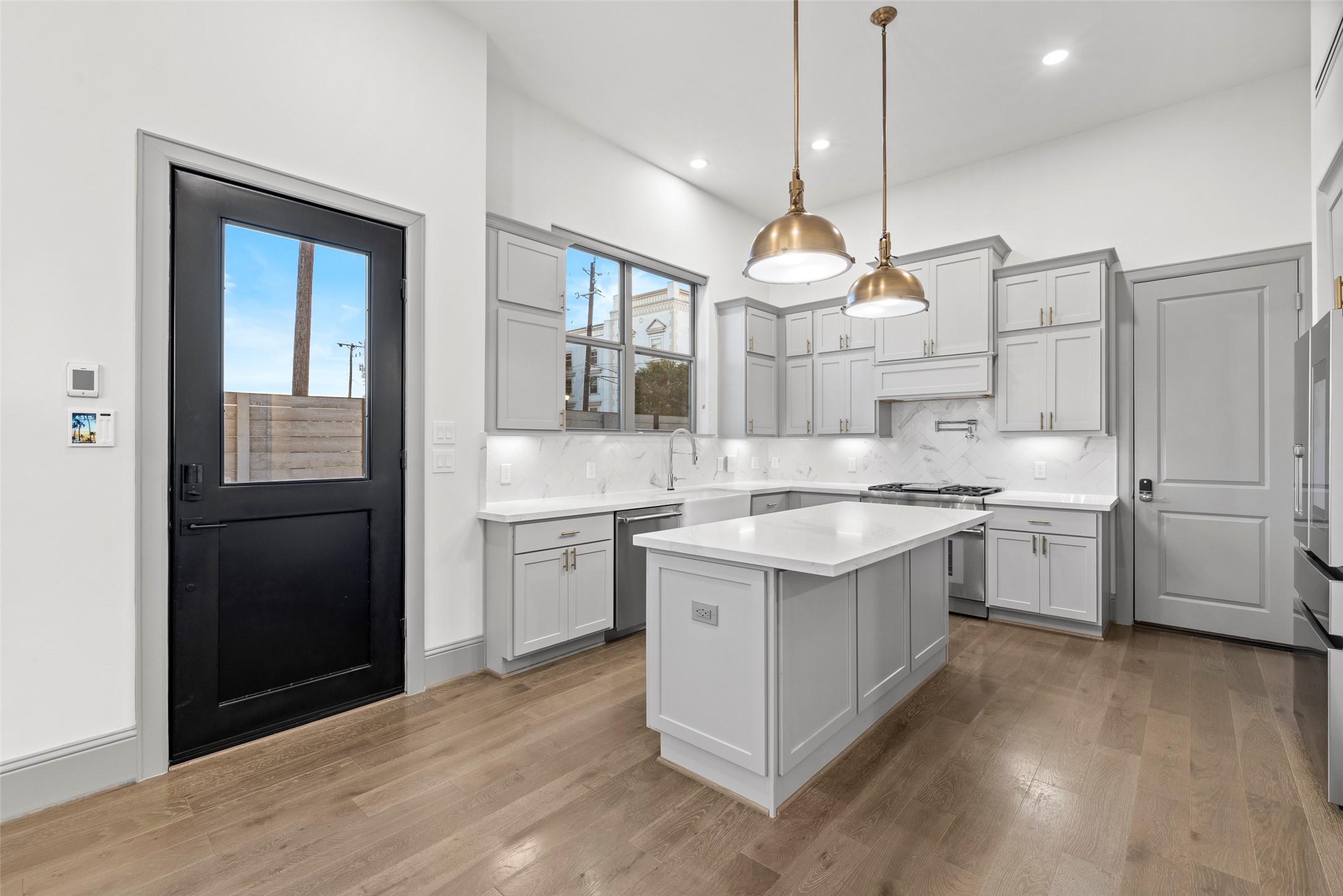 1719 Holman Street Houston, TX 77004 - Photo 7 of 40 a kitchen with stainless steel appliances granite countertop a sink a stove a refrigerator and island with wooden floor