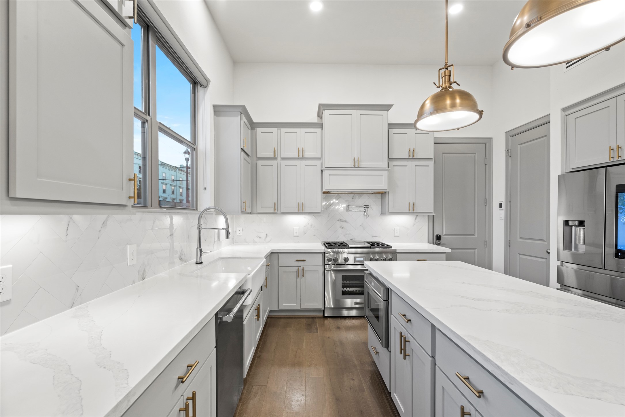 1719 Holman Street Houston, TX 77004 - Photo 8 of 40 a kitchen with a stove a sink a center island and a cabinets