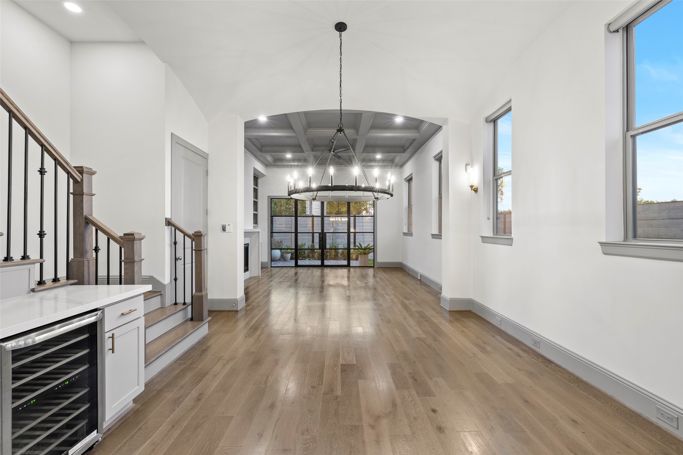 1719 Holman Street Houston, TX 77004 - Photo 9 of 40 a view of a room with wooden floor staircase and a kitchen